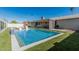 Backyard pool with a waterfall feature, seating, a covered patio, and lush turf, ideal for entertaining at 8522 E Virginia Ave, Scottsdale, AZ 85257