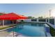 Backyard swimming pool with waterfall feature, surrounded by lush landscaping and lounge chairs at 8522 E Virginia Ave, Scottsdale, AZ 85257