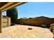 Open patio with a fire pit, shed, landscaping, and perimeter wall at 10065 E Tiger Lily Ave, Mesa, AZ 85212