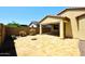 Extended backyard patio and landscape featuring a covered patio, an outdoor firepit, and shrubbery at 10065 E Tiger Lily Ave, Mesa, AZ 85212