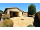 Private backyard with a covered patio, desert landscape, and a shed, perfect for outdoor entertaining at 10065 E Tiger Lily Ave, Mesa, AZ 85212