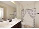 Cozy bathroom with a single vanity and a tub-shower with a cactus-themed curtain at 10065 E Tiger Lily Ave, Mesa, AZ 85212