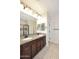Bathroom featuring a double vanity with granite countertops and a separate tiled shower at 10065 E Tiger Lily Ave, Mesa, AZ 85212