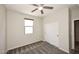 Neutral bedroom with a ceiling fan, carpet, window, and sliding door closet at 10065 E Tiger Lily Ave, Mesa, AZ 85212