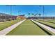 Well-kept bocce ball courts with lush green surfaces and clear markings, ideal for friendly competition and outdoor fun at 10065 E Tiger Lily Ave, Mesa, AZ 85212