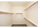 Walk-in closet with wooden shelves and ample storage space, providing organization at 10065 E Tiger Lily Ave, Mesa, AZ 85212