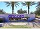 Community entrance featuring an 'encore' sign with palm trees and lush landscaping, creating a welcoming atmosphere at 10065 E Tiger Lily Ave, Mesa, AZ 85212