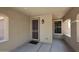 Covered entryway with security door, updated lighting, and neutral color scheme at 10065 E Tiger Lily Ave, Mesa, AZ 85212