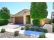 Charming single-story home featuring mature trees, a driveway, and low-maintenance landscaping at 10065 E Tiger Lily Ave, Mesa, AZ 85212