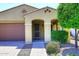 Charming single-story home featuring desert landscaping, a 2-car garage, and an arched entryway at 10065 E Tiger Lily Ave, Mesa, AZ 85212