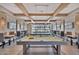 Elegant game room with multiple pool tables, comfortable seating, and stylish lighting perfect for entertaining guests at 10065 E Tiger Lily Ave, Mesa, AZ 85212