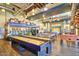 A spacious game room offering activities such as shuffleboard, billiards, and foosball at 10065 E Tiger Lily Ave, Mesa, AZ 85212