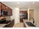 Beautiful kitchen with stainless steel appliances, granite countertops, and dark cabinetry at 10065 E Tiger Lily Ave, Mesa, AZ 85212