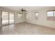 Spacious living room with tile flooring, large windows, and access to the outdoor patio area at 10065 E Tiger Lily Ave, Mesa, AZ 85212