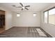 Spacious main bedroom with multiple windows and a ceiling fan providing comfort and ample light at 10065 E Tiger Lily Ave, Mesa, AZ 85212
