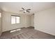 Bright main bedroom with neutral walls, carpet flooring, and a ceiling fan offering optimal comfort at 10065 E Tiger Lily Ave, Mesa, AZ 85212