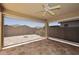 Relaxing covered patio featuring a ceiling fan and an unobstructed view of the private backyard at 10065 E Tiger Lily Ave, Mesa, AZ 85212