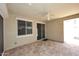 Covered patio with tile flooring, ceiling fan, and sliding glass doors for indoor-outdoor living at 10065 E Tiger Lily Ave, Mesa, AZ 85212
