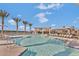 Resort-style pool surrounded by palm trees and comfortable lounge chairs, creating a relaxing oasis at 10065 E Tiger Lily Ave, Mesa, AZ 85212