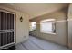 Covered entryway featuring a security door, updated lighting, and a neutral color scheme at 10065 E Tiger Lily Ave, Mesa, AZ 85212