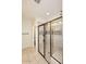 Modern tiled shower with glass doors and bronze fixtures, creating a sleek design at 10065 E Tiger Lily Ave, Mesa, AZ 85212