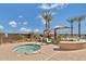 Inviting hot tub area with palm trees, lounge chairs, and scenic views, perfect for relaxation and unwinding at 10065 E Tiger Lily Ave, Mesa, AZ 85212
