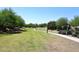 Scenic walking path meanders through lush landscaping in a well maintained green space at 10065 E Tiger Lily Ave, Mesa, AZ 85212