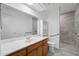 Bathroom features a large mirror, white countertops, and tiled walk-in shower at 1021 S Greenfield Rd # 1077, Mesa, AZ 85206