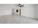 Spacious living room with tile floors, modern lighting, and an open layout to the kitchen at 1021 S Greenfield Rd # 1077, Mesa, AZ 85206