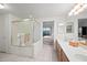 Well-lit bathroom with dual sinks, shower, and serene view of the bedroom offering relaxation and convenience at 10410 N Cave Creek Rd # 1100, Phoenix, AZ 85020