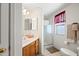 Bright bathroom with a walk-in shower, modern vanity, and neutral tile flooring at 10410 N Cave Creek Rd # 1100, Phoenix, AZ 85020