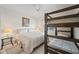 Bedroom features a bunk bed and a queen size bed with neutral tones and a ceiling fan at 10410 N Cave Creek Rd # 1100, Phoenix, AZ 85020