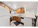 Cozy kitchen with oak cabinets, white appliances, and a breakfast bar that's perfect for everyday living at 10410 N Cave Creek Rd # 1100, Phoenix, AZ 85020