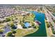 Aerial view of the community featuring a lake, playground, and lush green spaces at 1104 E Tekoa Ave, Gilbert, AZ 85298