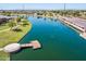 Scenic aerial view of the lake featuring a dock, bridge, and lush landscaping at 1104 E Tekoa Ave, Gilbert, AZ 85298