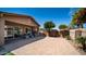 Covered patio and paved backyard with lounge furniture, ideal for outdoor entertaining at 1104 E Tekoa Ave, Gilbert, AZ 85298