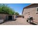 Backyard with gravel ground, BBQ grill, storage shed, and view of the house at 1104 E Tekoa Ave, Gilbert, AZ 85298