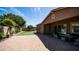 Wide view of the backyard, with a paved patio, artificial turf and desert landscaping at 1104 E Tekoa Ave, Gilbert, AZ 85298