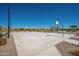 Community basketball court with multiple hoops, picnic tables, walking paths, and lush landscaping for outdoor recreational activities at 1104 E Tekoa Ave, Gilbert, AZ 85298