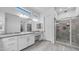 A bright bathroom offers double sinks, a glass-enclosed shower with tile surround, and ample counter space at 1104 E Tekoa Ave, Gilbert, AZ 85298