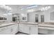 A spacious bathroom with double sinks, white cabinets, quartz countertop, and a large mirror offers luxury at 1104 E Tekoa Ave, Gilbert, AZ 85298