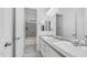 Bathroom with double sink vanity, tiled floors, and shower-tub combo at 1104 E Tekoa Ave, Gilbert, AZ 85298
