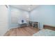 A blue bedroom features a desk, bookcase, and a single bed, creating a cozy and functional space at 1104 E Tekoa Ave, Gilbert, AZ 85298