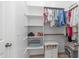 The closet has built-in shelving, storage space, and rods for organizing clothes with a small bench at 1104 E Tekoa Ave, Gilbert, AZ 85298