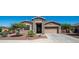 Charming single-story home with stone accents, desert landscaping, and a two-car garage at 1104 E Tekoa Ave, Gilbert, AZ 85298