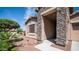 Charming single-story home with stone accents, manicured landscaping, and a welcoming entrance at 1104 E Tekoa Ave, Gilbert, AZ 85298