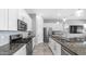 Updated kitchen features granite countertops, stainless steel appliances, and white cabinets at 1104 E Tekoa Ave, Gilbert, AZ 85298