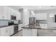 Modern kitchen with granite countertops, stainless steel appliances, and ample storage at 1104 E Tekoa Ave, Gilbert, AZ 85298