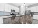 Close-up of granite countertops, stainless steel appliances, and pendant lighting in kitchen at 1104 E Tekoa Ave, Gilbert, AZ 85298