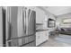 Modern kitchen with stainless steel refrigerator and open view into the living room at 1104 E Tekoa Ave, Gilbert, AZ 85298